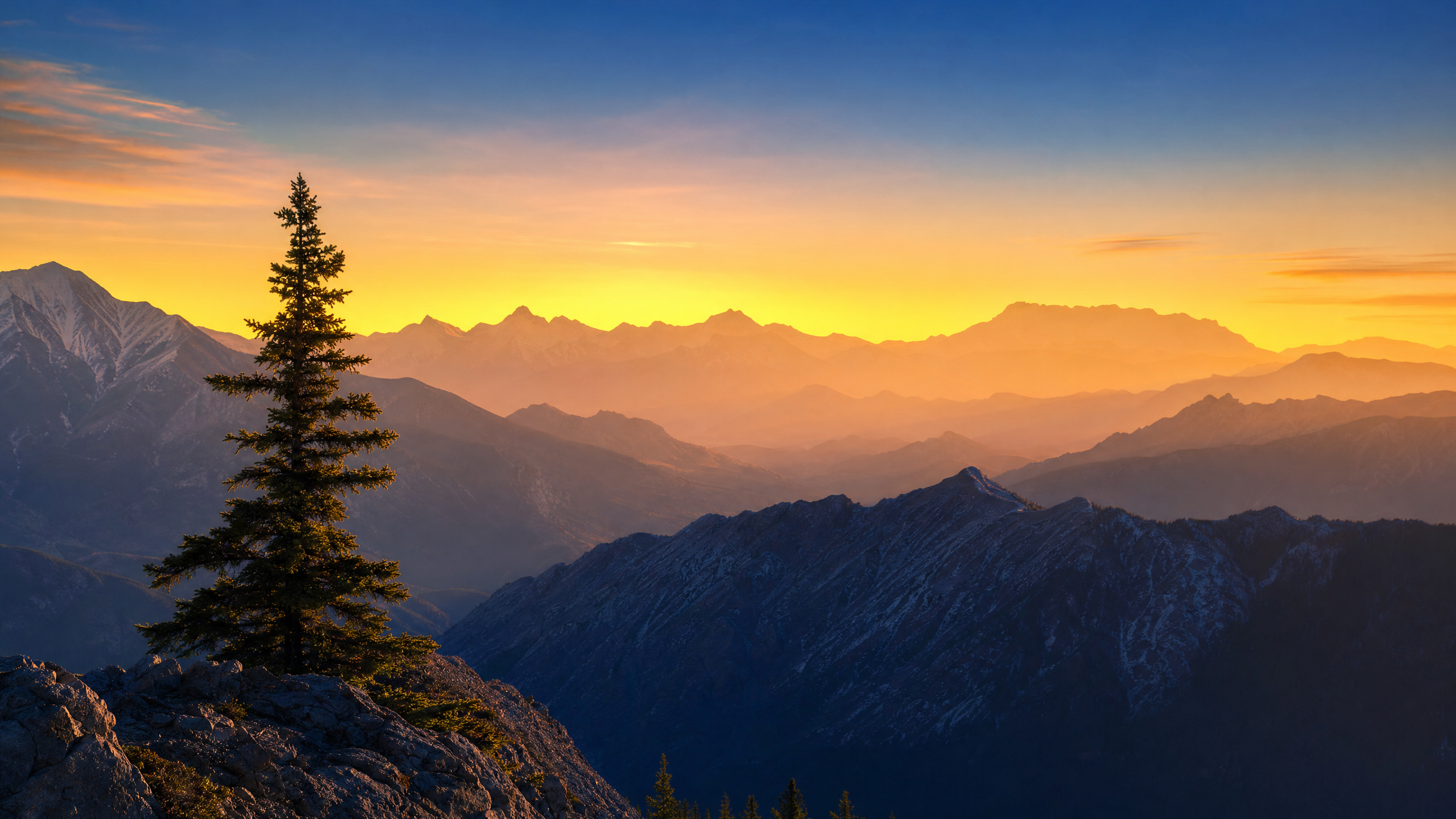 Layered mountain ridges at sunrise